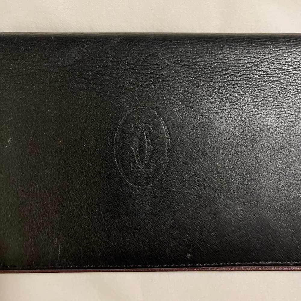 Cartier Calfskin Black long wallet w maroon inside, silver scroll on corners